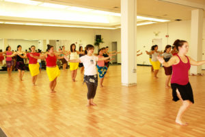 Dancers practicing Tahitian movements in unison